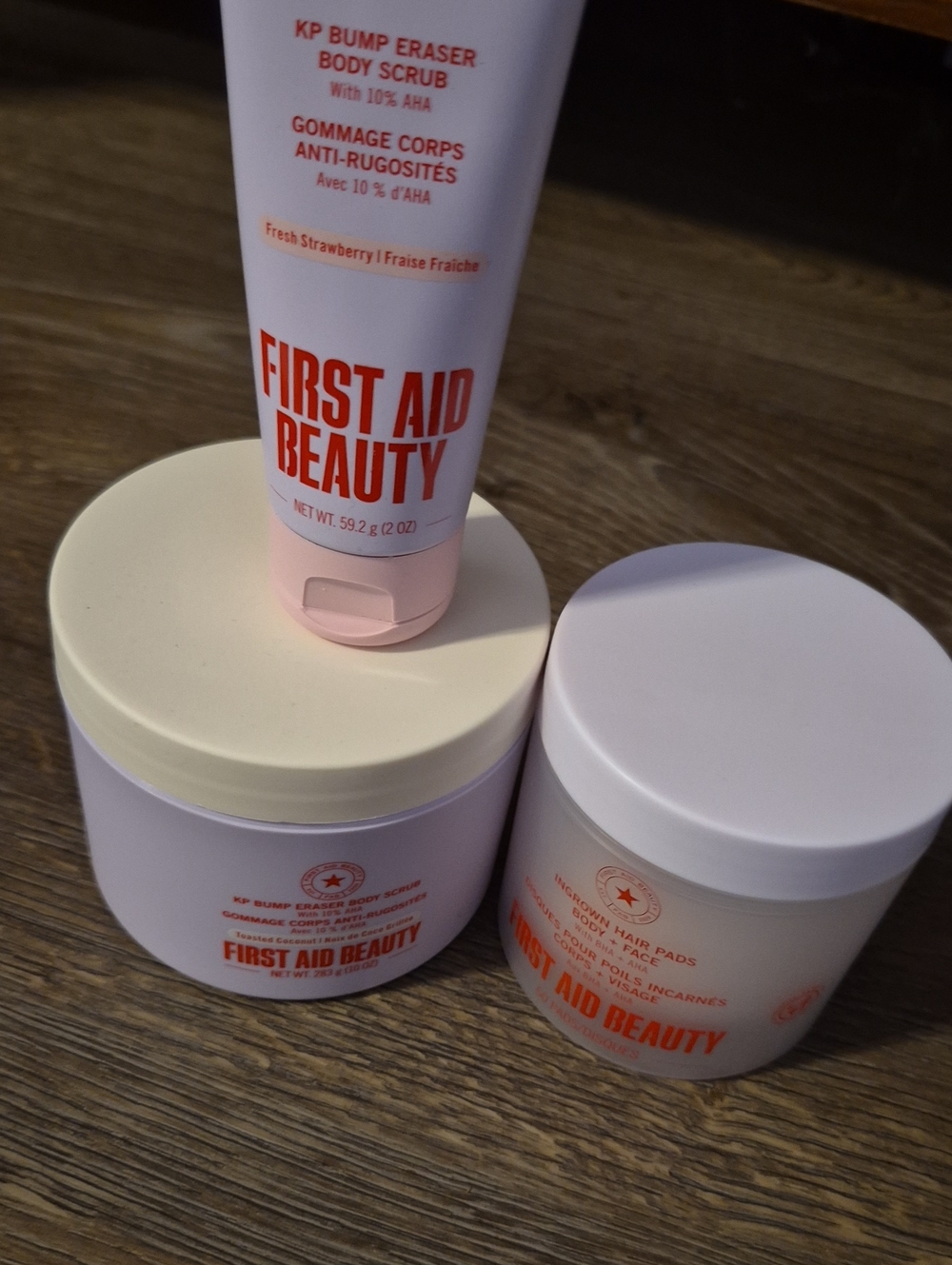 First Aid Beauty Body Scrub & Skincare Jars in Light Pink and Cream